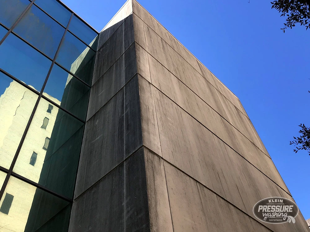 Black algae on downtown Houston concrete building